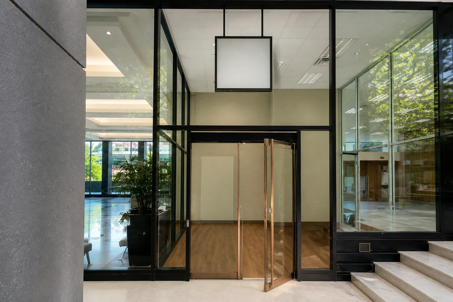 Tall glass commercial entrance with automatic doors